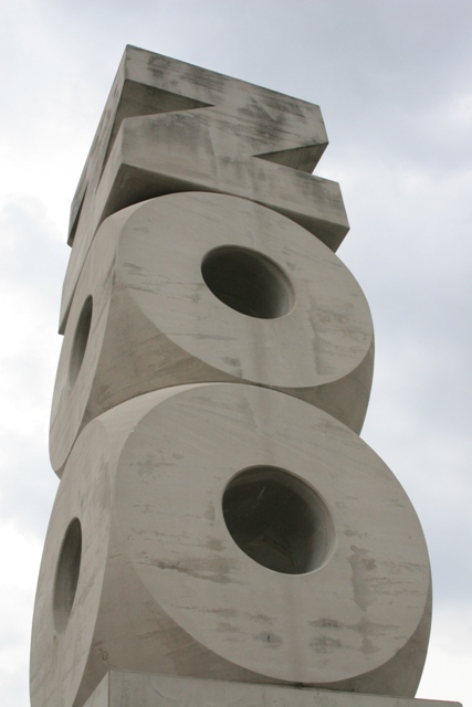 tall three dimensional concrete sculpture of the letters Z - O - O.